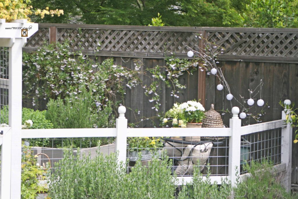 queen bee decor vignette in the vegetable garden
