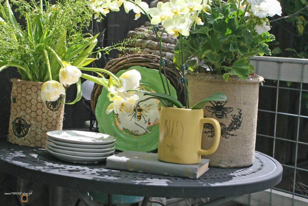 queen bee decor vignette in the vegetable garden