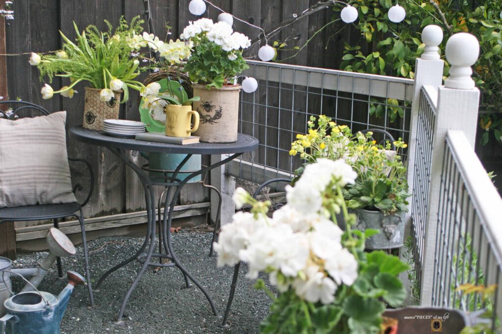 queen bee decor vignette in the vegetable garden