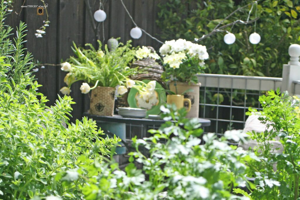 queen bee decor vignette in the vegetable garden