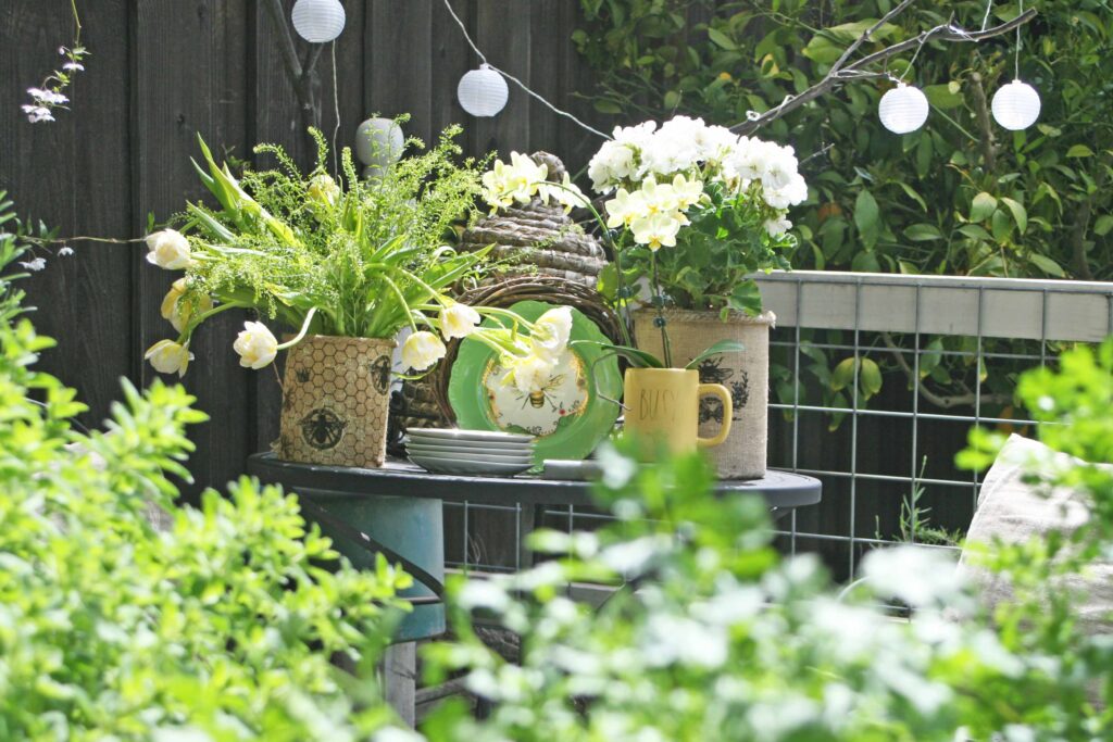 queen bee decor vignette in the vegetable garden