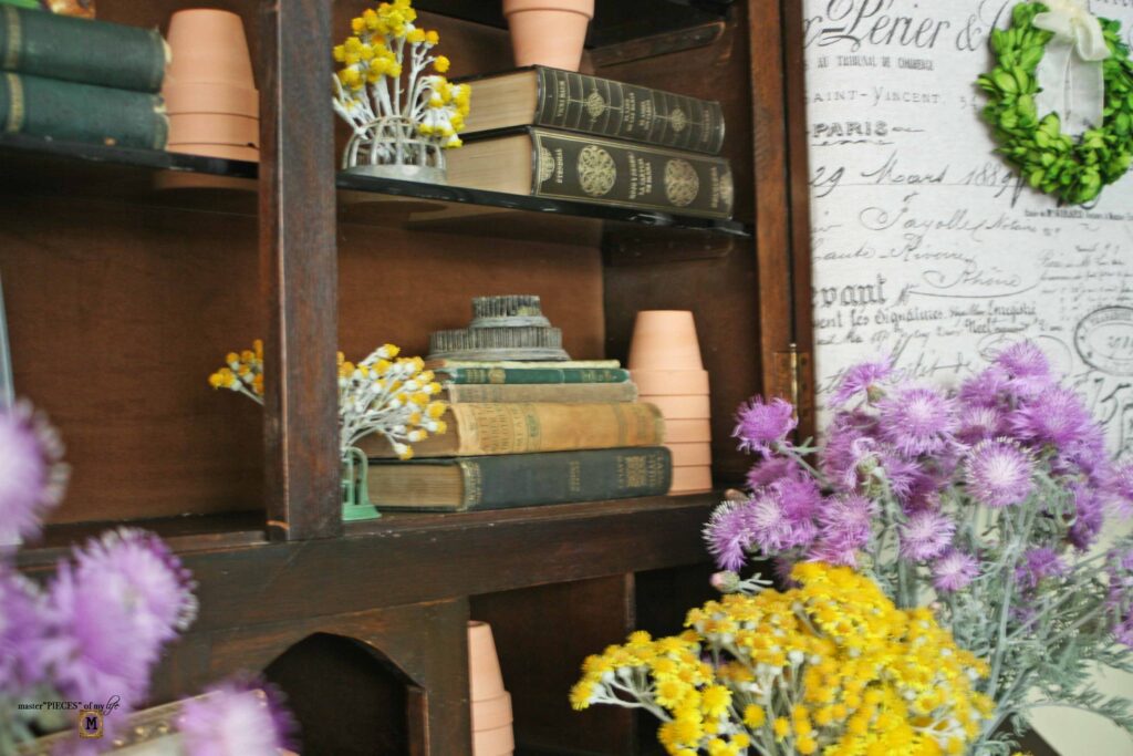 garden decor in an antique secretary desk