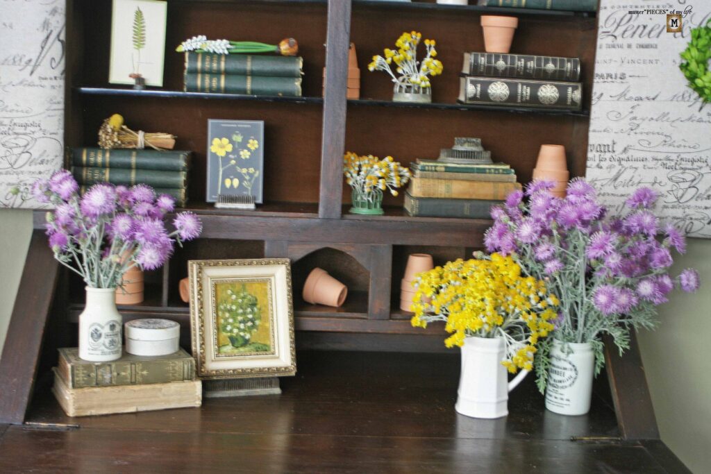 garden decor in an antique secretary desk