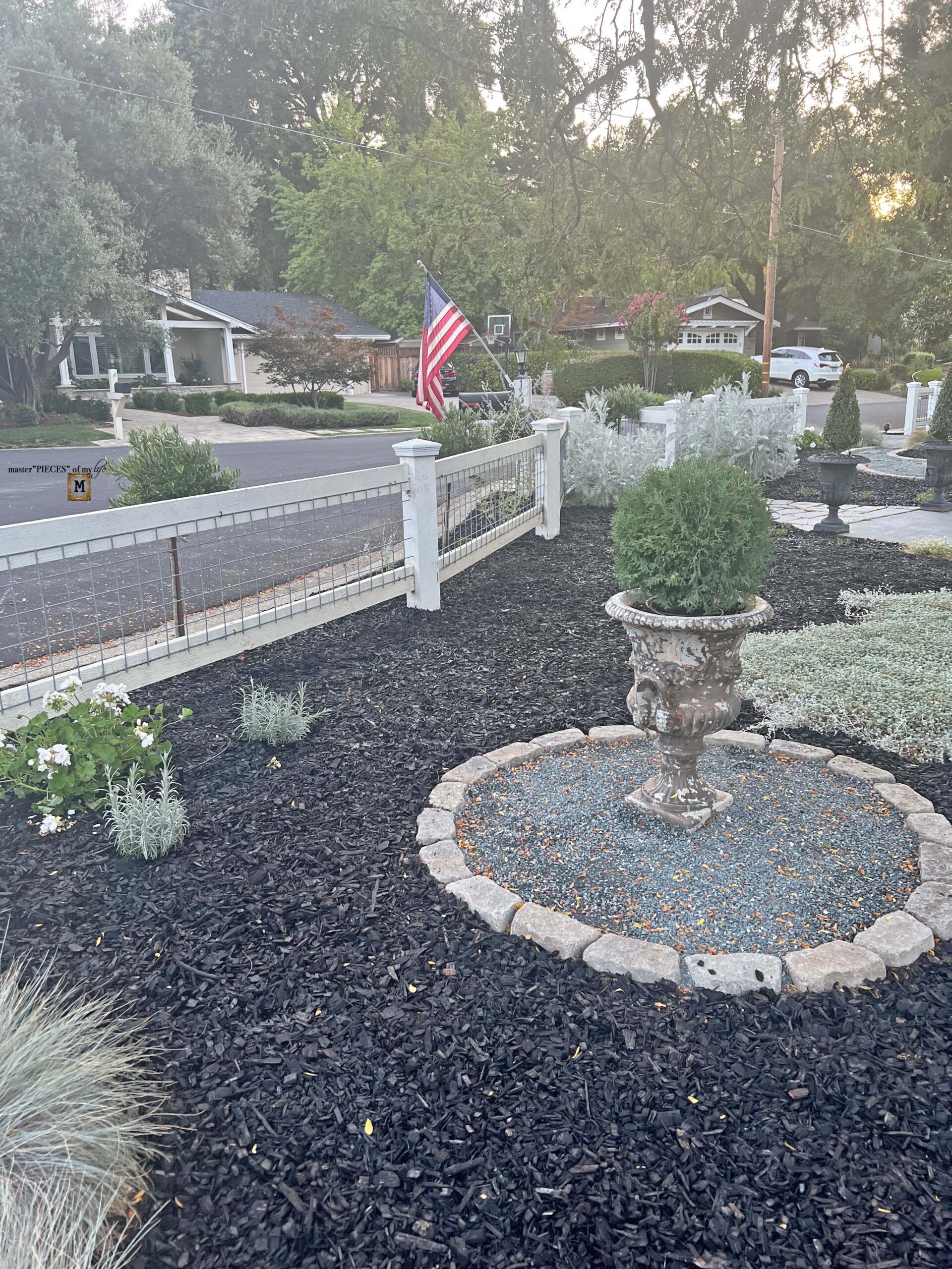 front yard fence. topiary urn