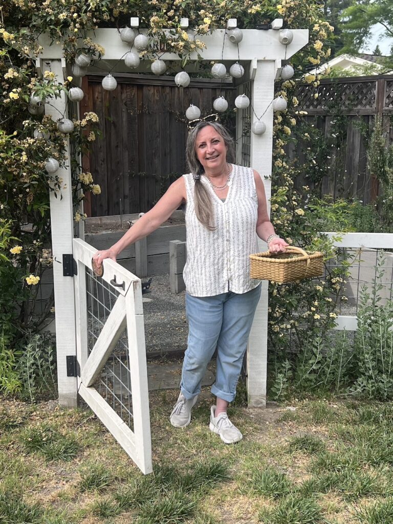 MaryJo in the garden with gathering basket