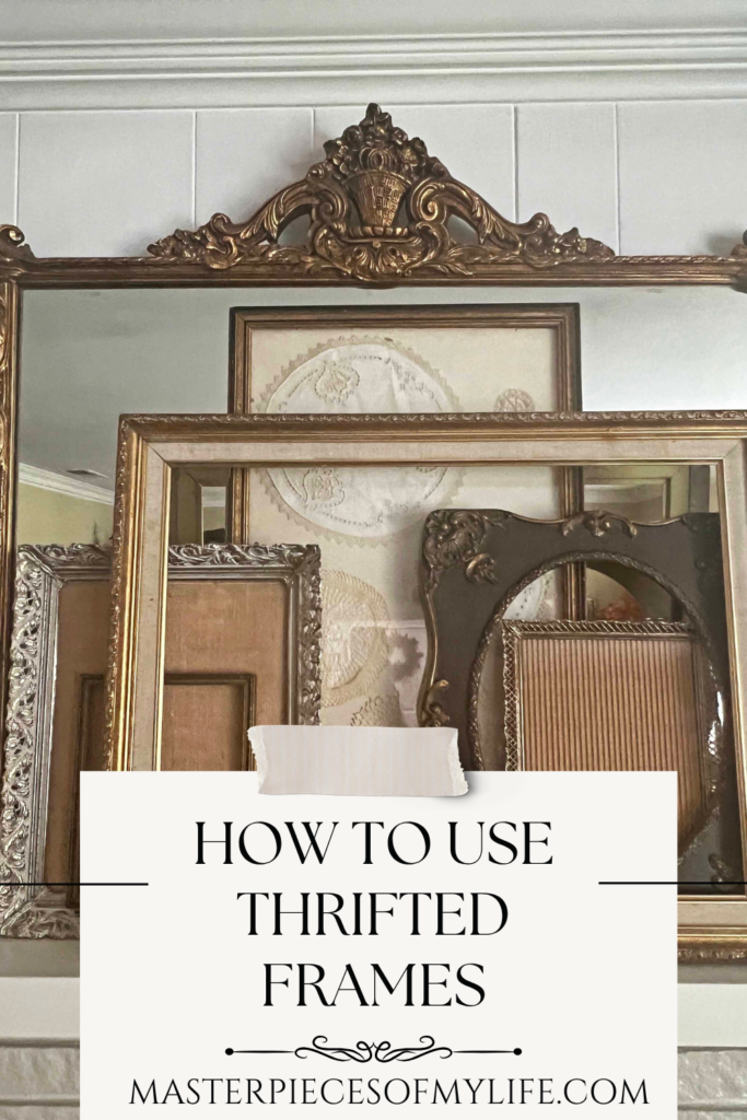 assorted vintage thrifted frames leaning on a gilded mirror on a mantel shelf