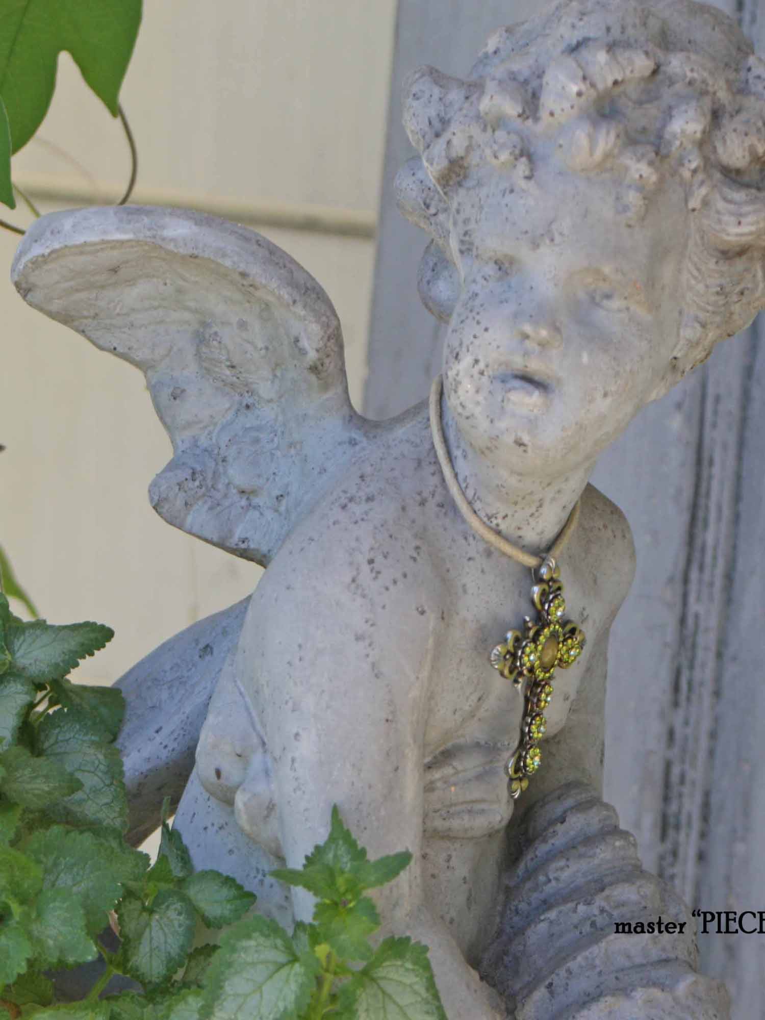 cherub garden statuary with jeweled cross