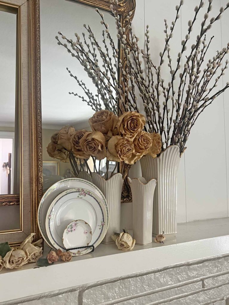 Summer fireplace mantel styling: A vintage rose inspired display for a collected home - thrifted plates, dried roses & pussy willows