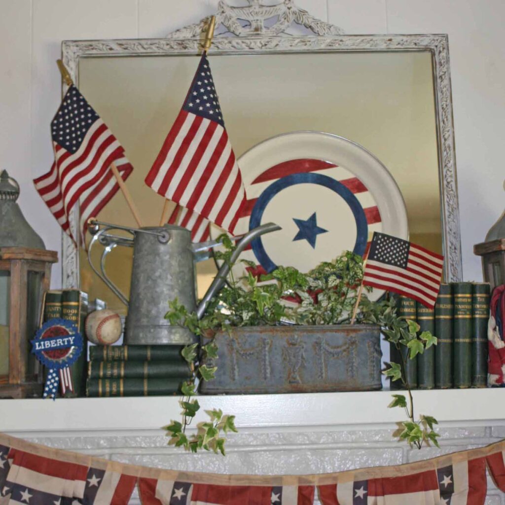 Patriotic mantel with flags books greenery and more
