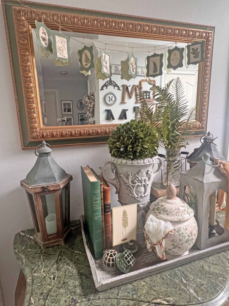 botanical summer decor vignette in the foyer angled bombe chest