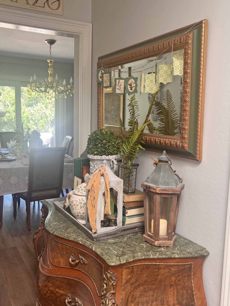 botanical summer decor vignette in the foyer angled towards dining room
