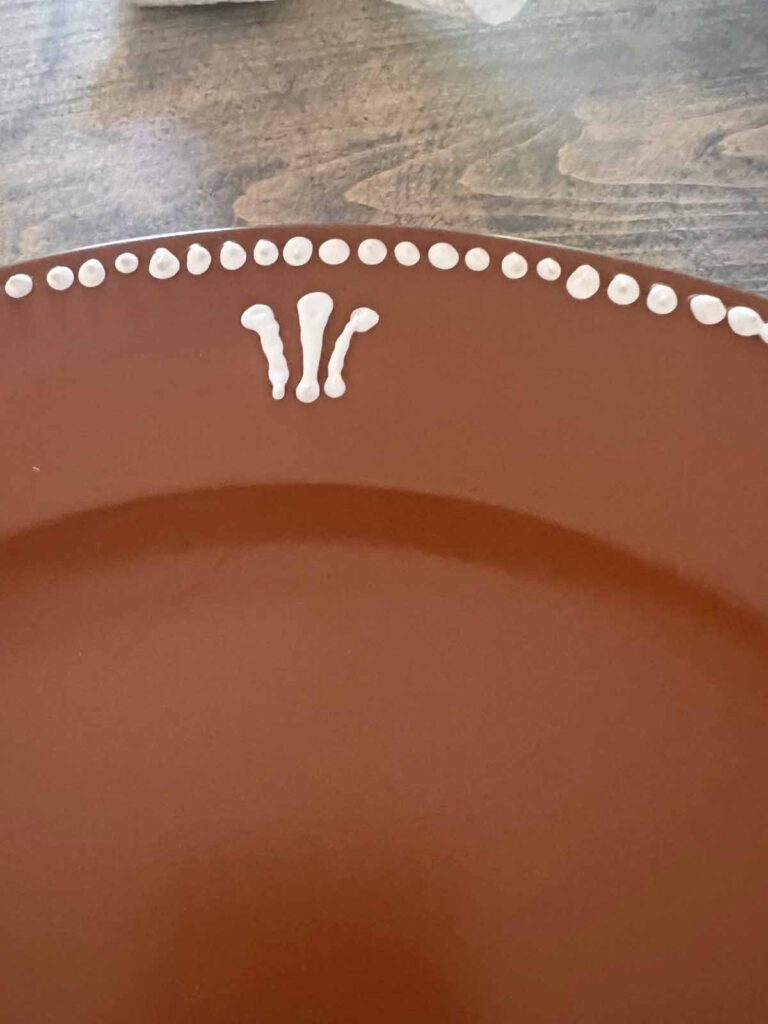 Christmas Craft: Gingerbread plate charger DIY {a la Pottery Barn} puffy paint first scroll applied