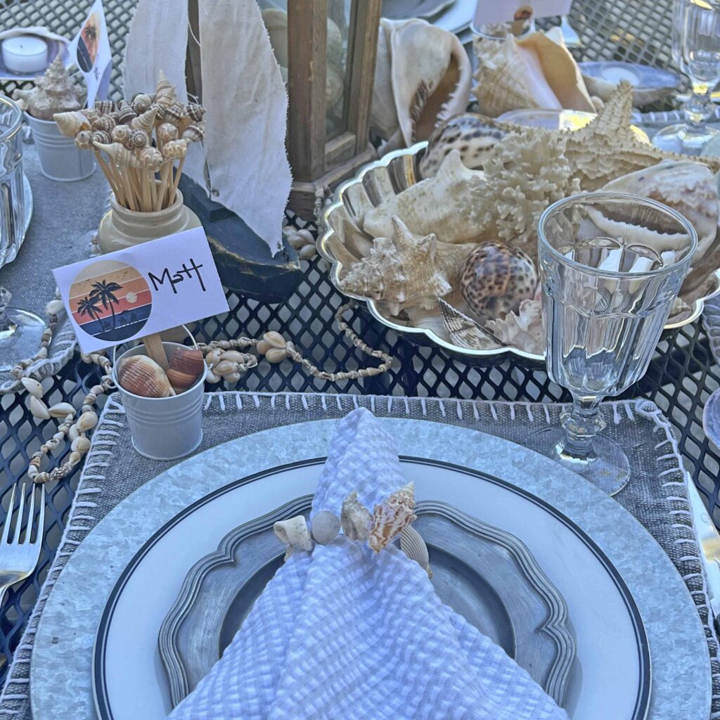 Beach inspired tablescape outdoors on black patio