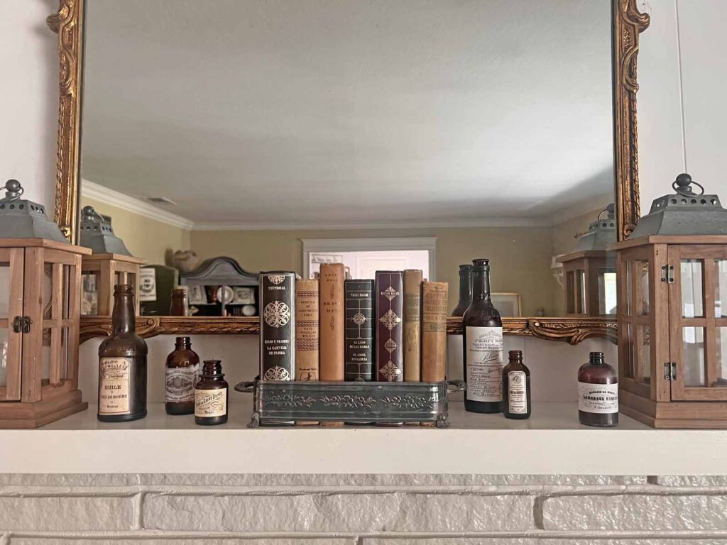 Fall Mantel Decor: Embracing the Essence of Fall Slowly- books in silver with bottles