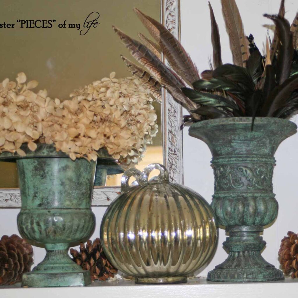 fall mantel styling with green urns, mercury glass pumpkins, pinecones, feathers and dried hydrangeas