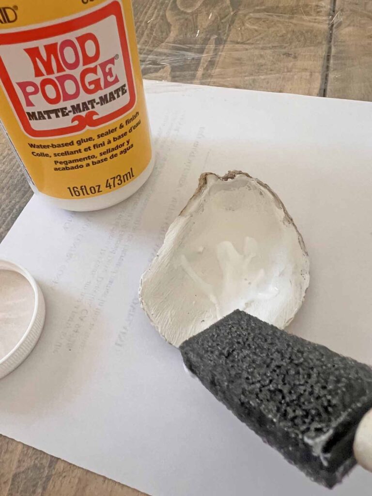 Summer craft: How to decoupage oyster shells into trend forward trinket dishes - mod podge application