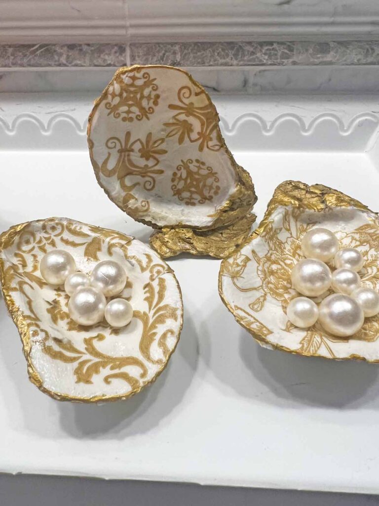 Summer craft: How to decoupage oyster shells into trend forward trinket dishes - styled on bathroom counter with faux pearls