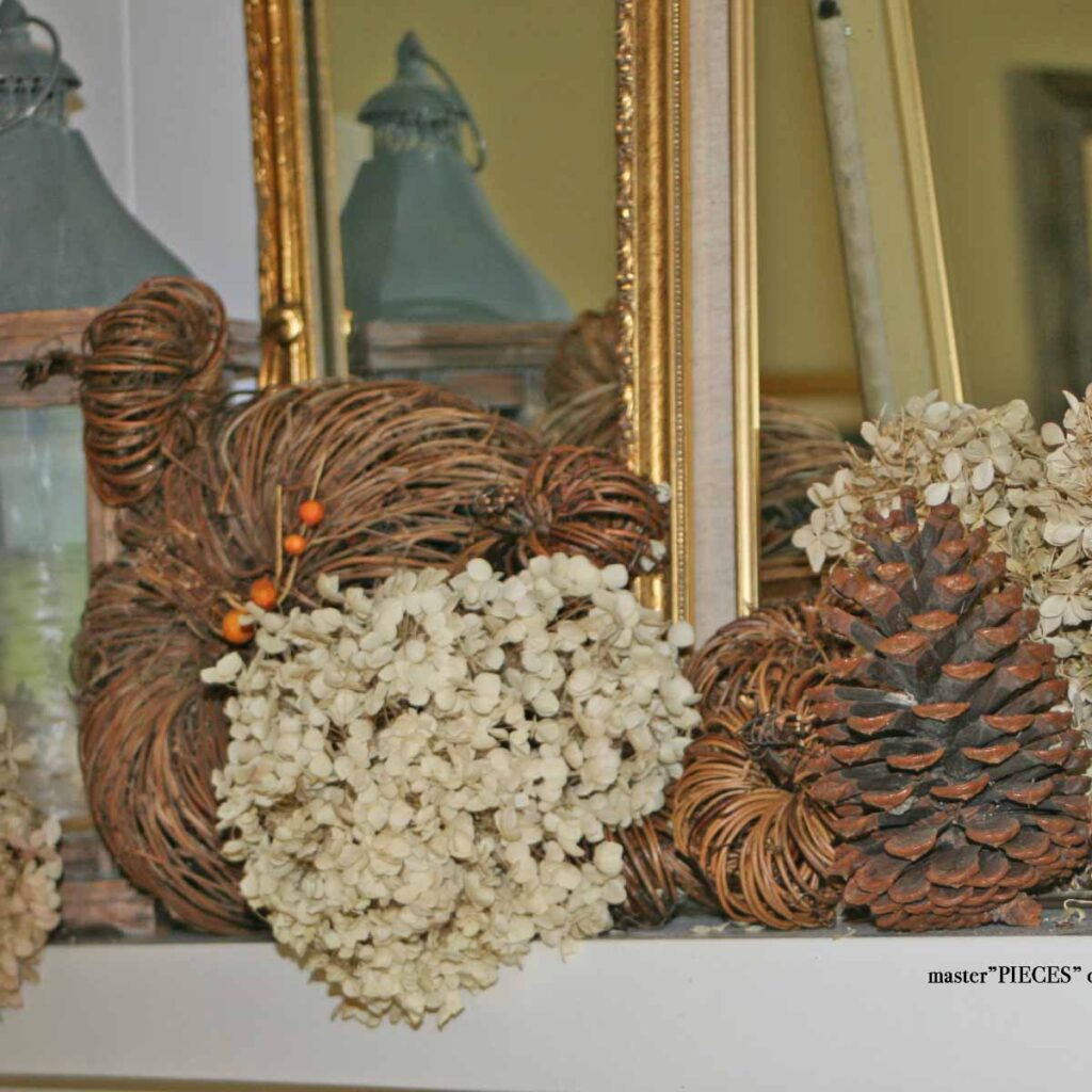 rustic autumn mantel styling with dried hydrangeas, twig pumpkins and pinecones