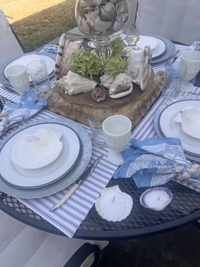 She sells seashells by the sea shore tablescape angled plate stack and place setting