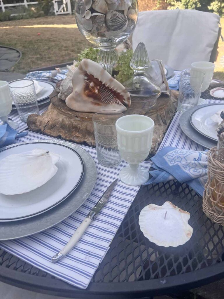 She sells seashells by the sea shore tablescape garden background