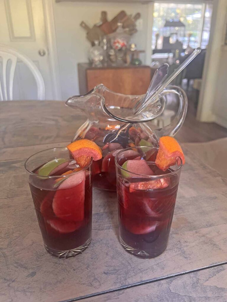 traditional red sangria recipe garnished glasses with pitcher