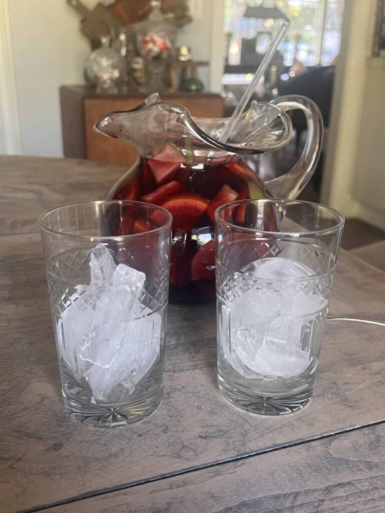 traditional red sangria recipe prepped glasses with ice and pitcher