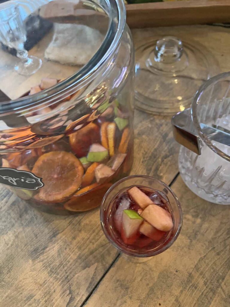 traditional red sangria recipe overhead with large container and ice bucket