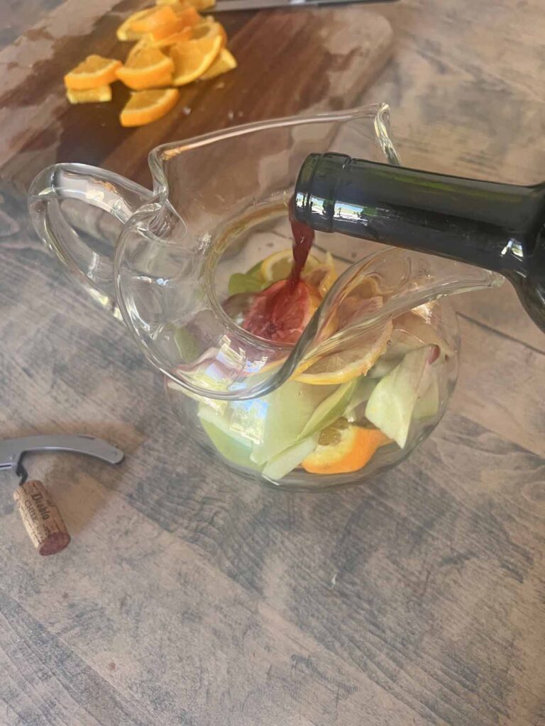 traditional red sangria recipe pouring wine over fruit