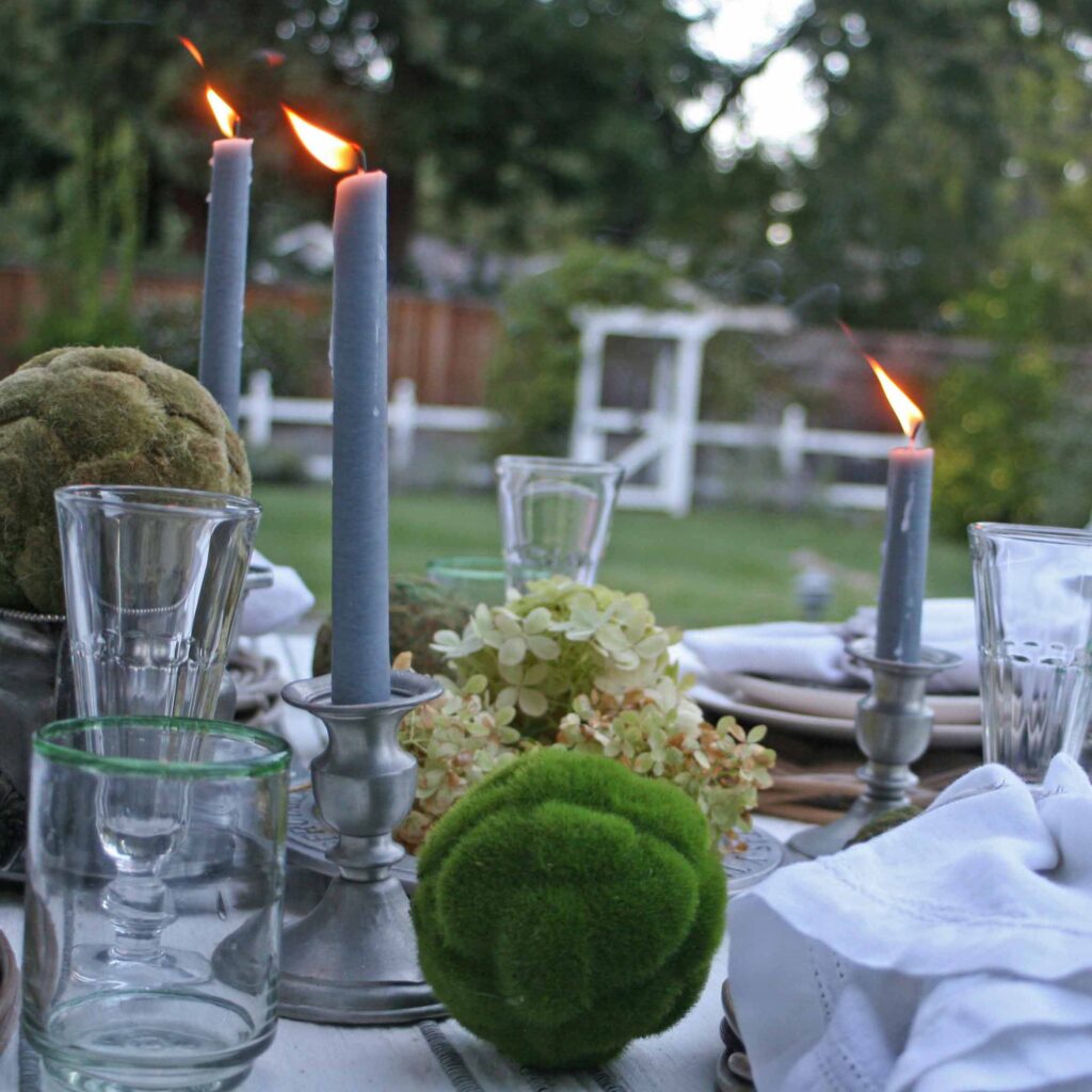 Thrifted pewter table outside with garden in the background