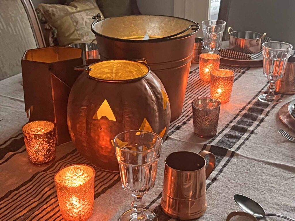 Halloween copper inspired table setting glowing jack-o-lanterns centerpiece inspo for the table
