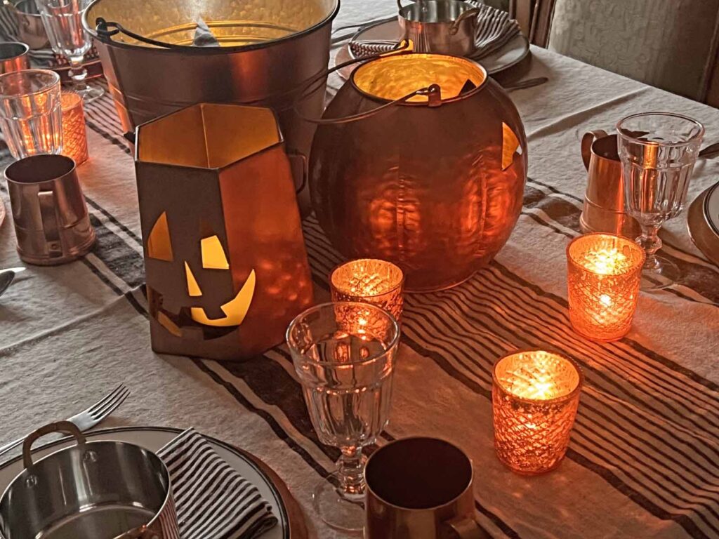 Halloween copper inspired table setting lanterns and votives lit up