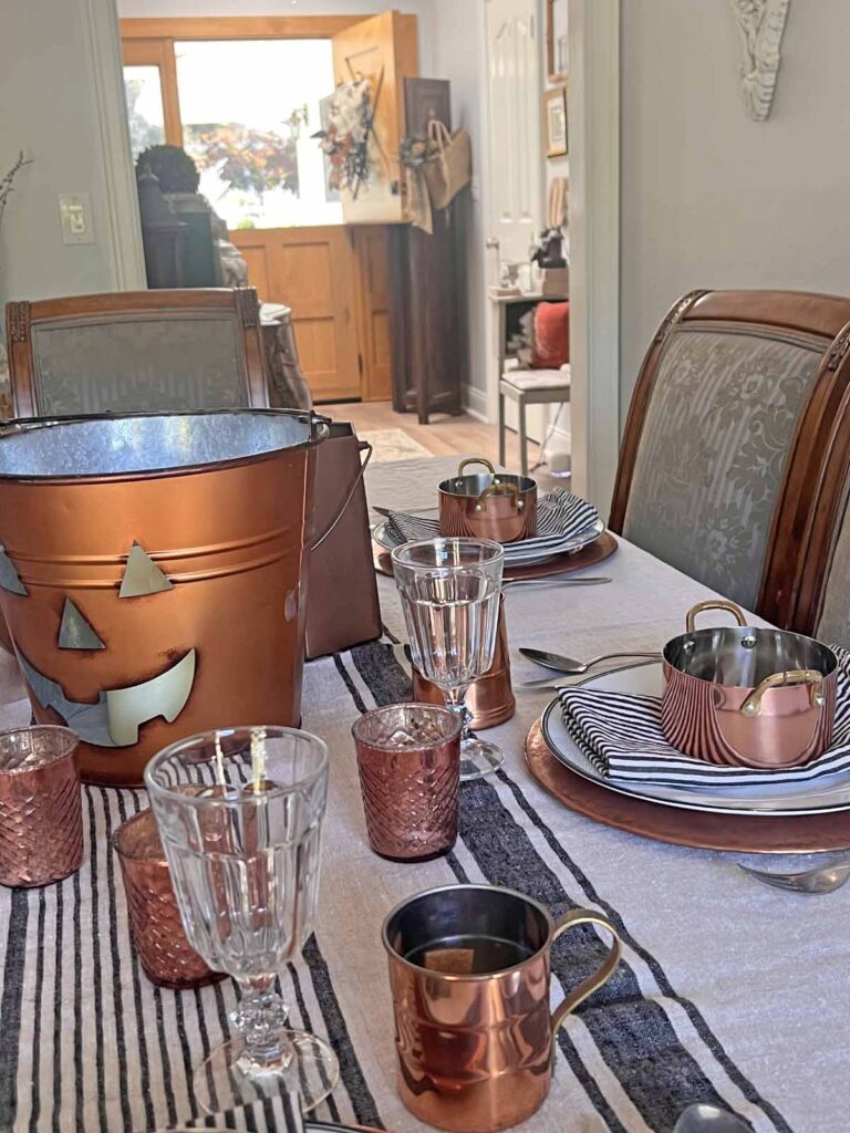 Halloween copper inspired table setting towards foyer with dutch for open