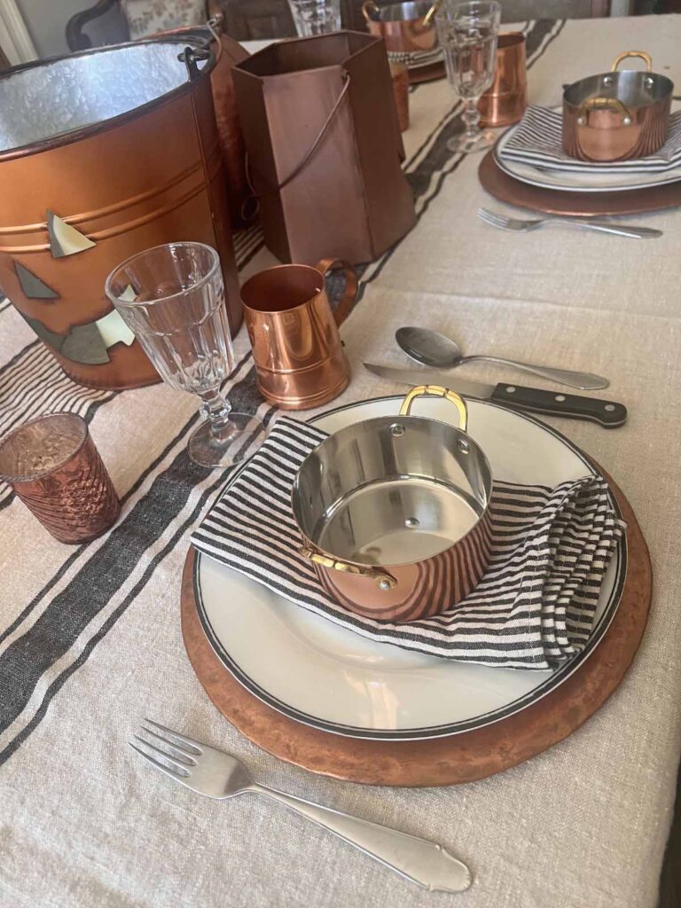 Halloween copper inspired table setting plate stack and place setting angled