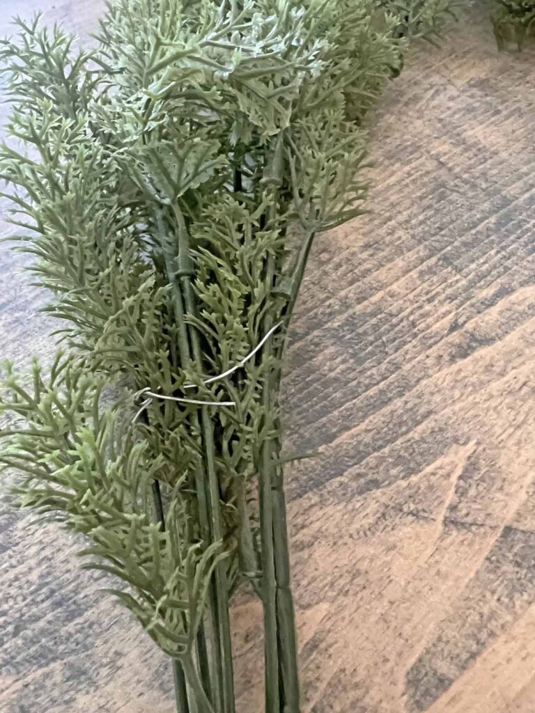 Another Anthropologie Dupe: Cascading black boughs Halloween garland DIY attaching greenery picks with wire