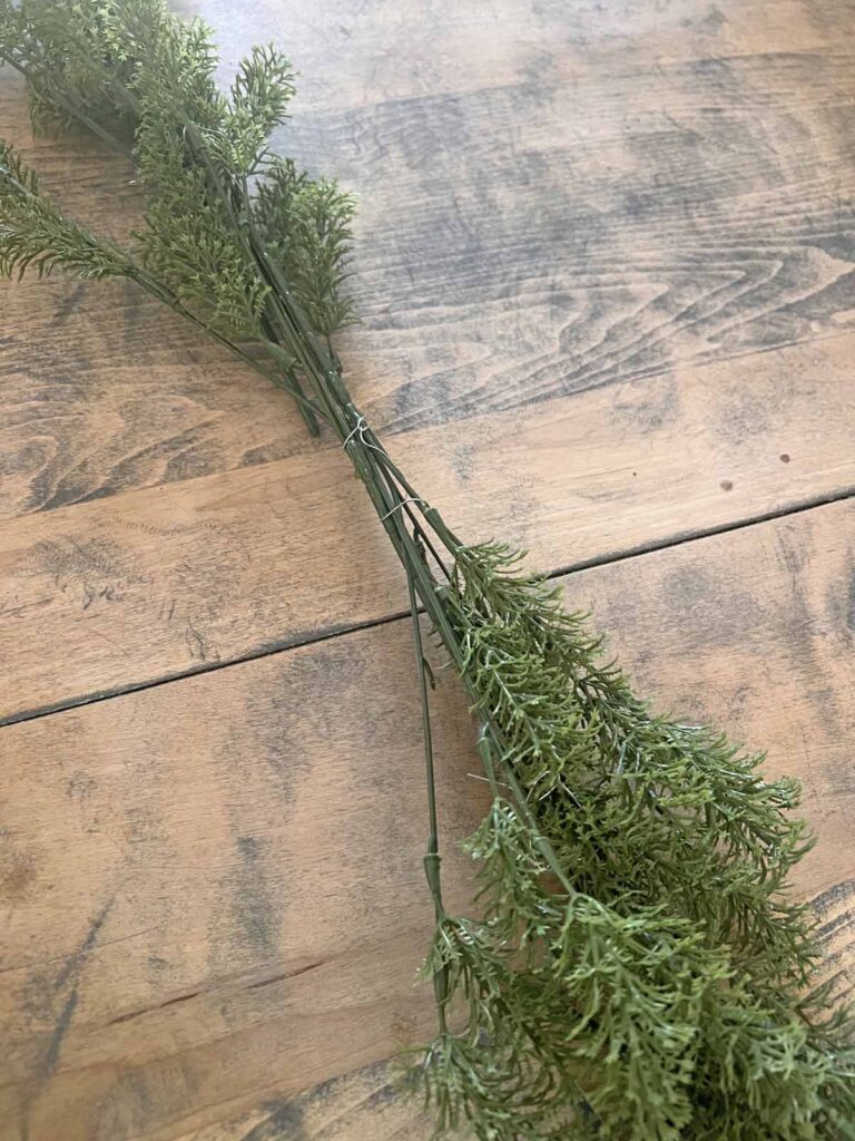 Another Anthropologie Dupe: Cascading black boughs Halloween garland DIY attaching both greenery sections in the middle