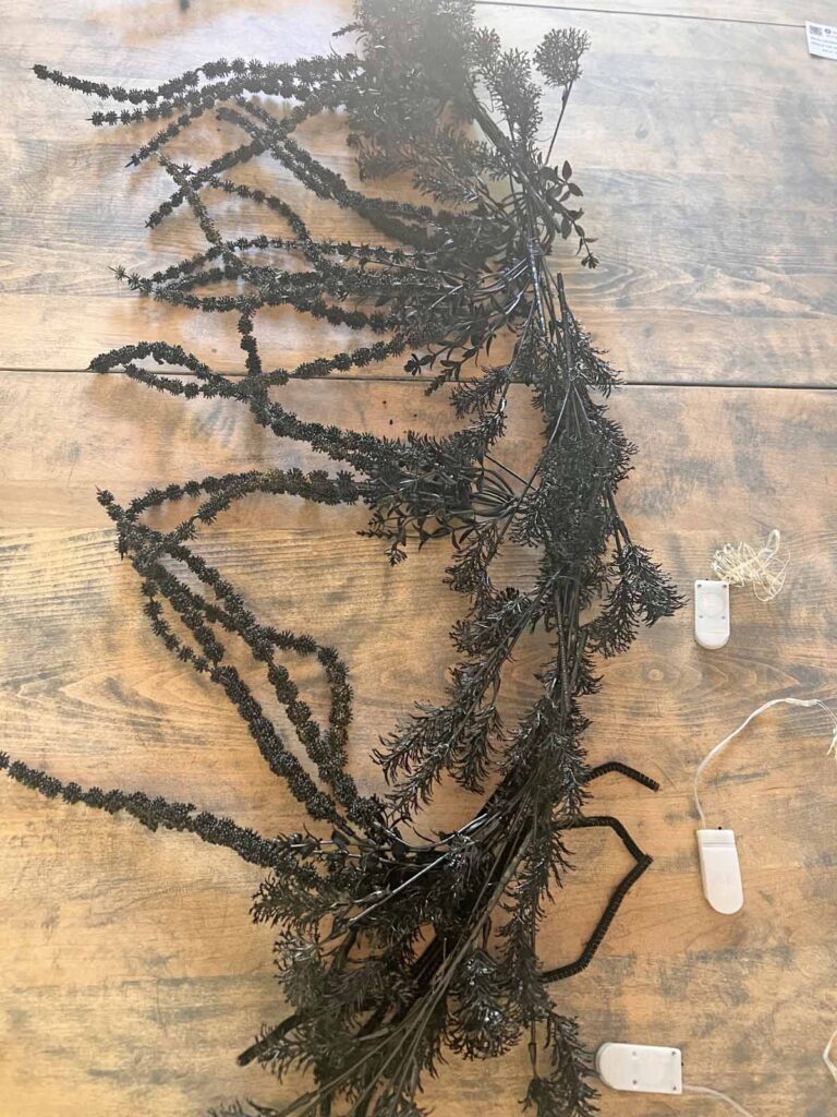 Another Anthropologie Dupe: Cascading black boughs Halloween garland DIY LED light prep