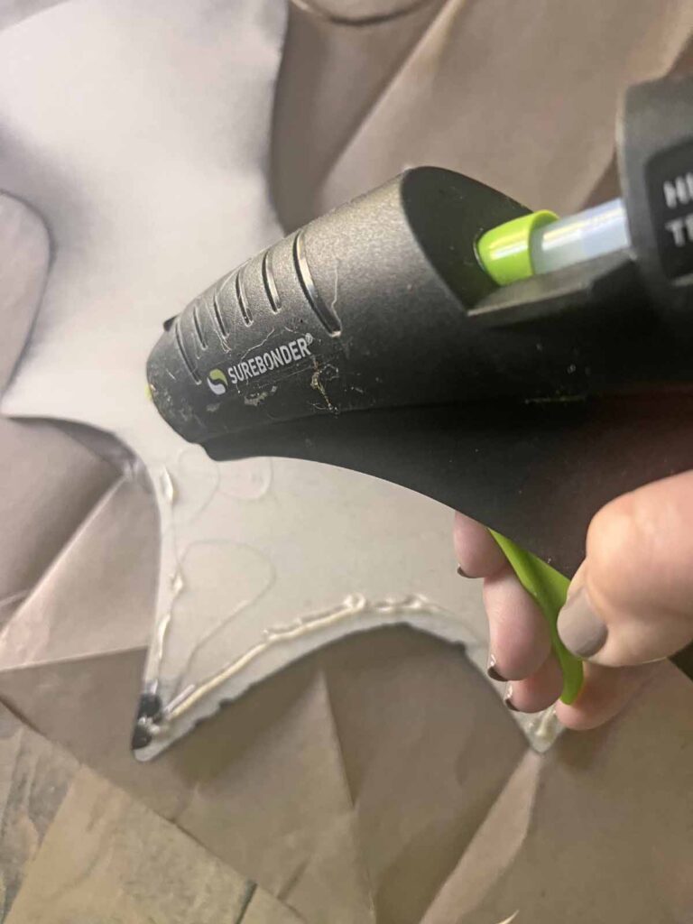 Halloween Decor: Faux tin tile bat DIY adding hot glue to wood bat