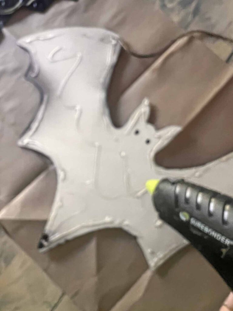 Halloween Decor: Faux tin tile bat DIY hot glue on wooden bat