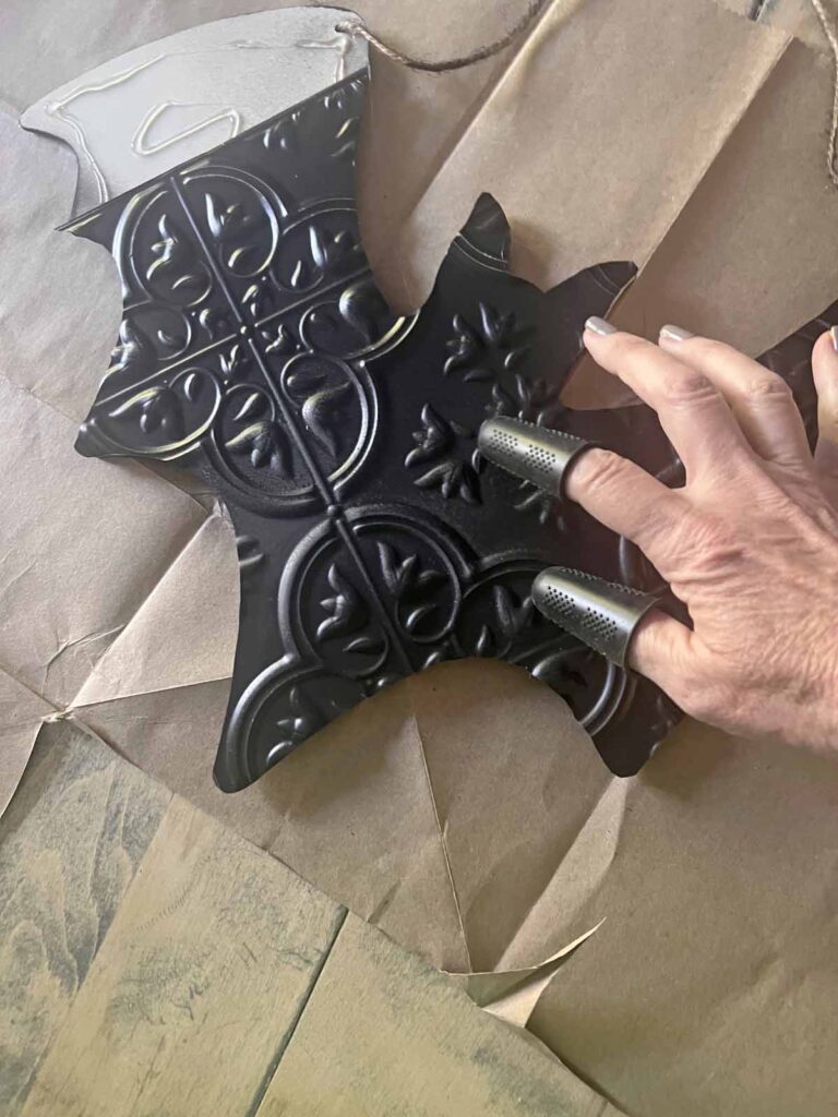 Halloween Decor: Faux tin tile bat DIY gluing tin tile to wooden bat