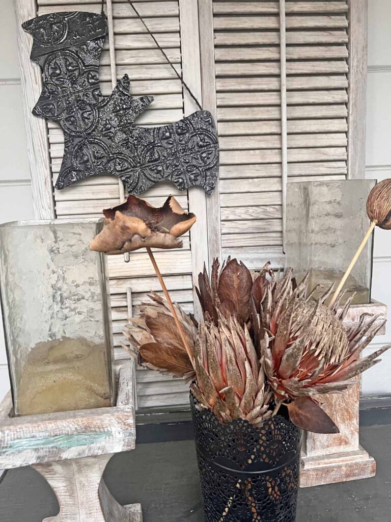 Halloween Decor: Faux tin tile bat DIY styled with moody flowers and rustic candle holders