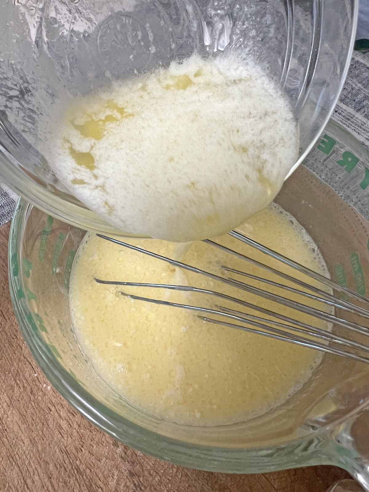 The easiest and most delicious cornbread recipe mixing melted butter into wet ingredients