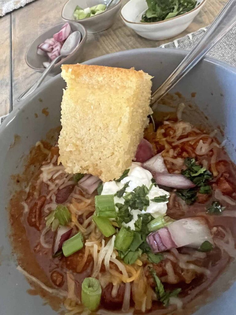 The easiest and most delicious cornbread served with a bowl of chili