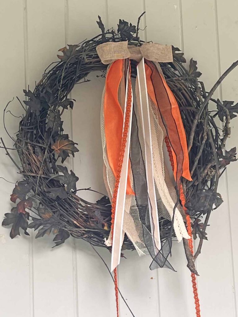 Seasonal Decor: Charming log tailed bow for a Classy Halloween accent angled close-up
