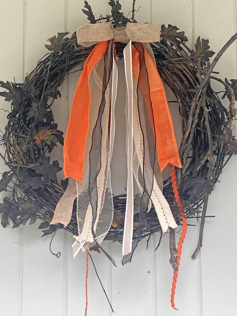 Seasonal Decor: Charming log tailed bow for a Classy Halloween accent on siding of house