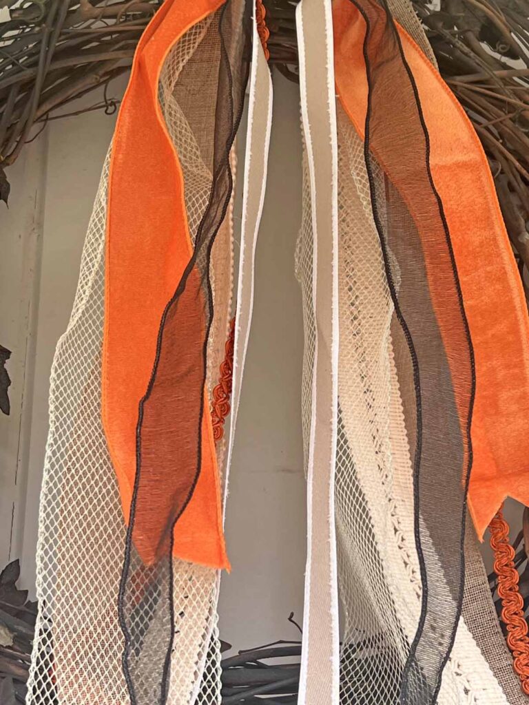 Seasonal Decor: Charming log tailed bow for a Classy Halloween accent long tailed ribbon movement