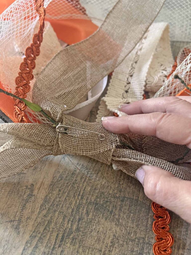 Seasonal Decor: Charming log tailed bow for a Classy Halloween accent knot tied with safety pin
