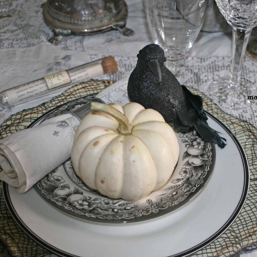 Stylish Halloween tablescape with blackbirds and white pumpkins