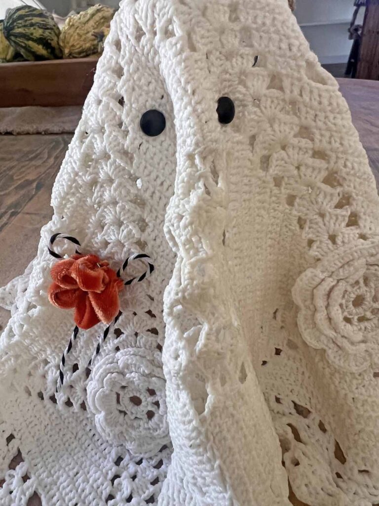 How to transform a thrifted Doily into Casper the friendly ghost for Halloween DIY close-up of embellishments